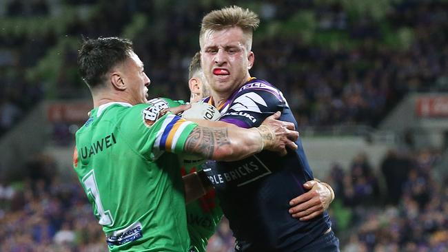 Storm star Cameron Munster is wrapped up by the Raiders defence. Pic: Michael Klein.