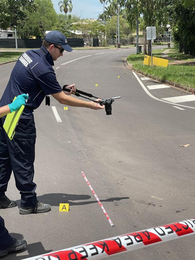 Forensic investigators examine blood stains on Driver Ave, near the intersection of Bailey Cct. Picture: Annabel Bowles