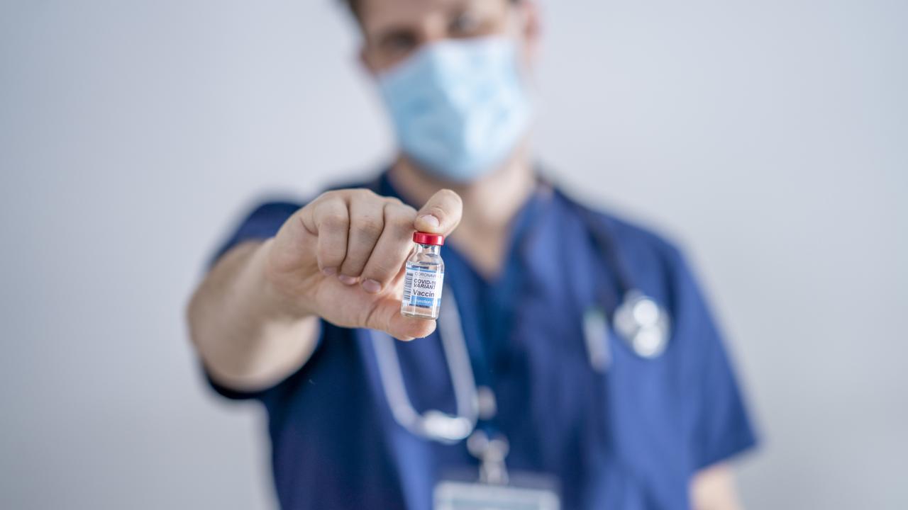 Male doctor holding a vial of the Coronavirus Variant Vaccine.