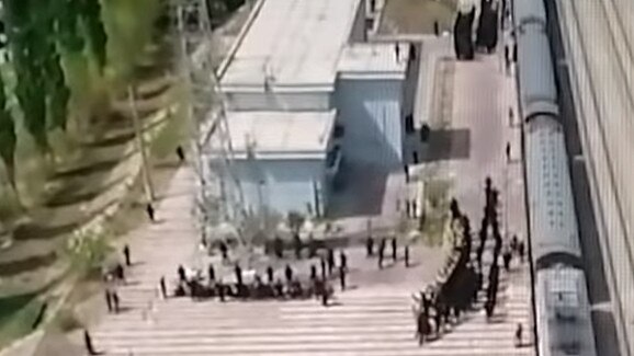 View from an aerial drone of blindfolded and shackled men outside a camp in China. Picture: YouTube