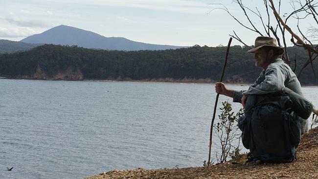 John Blay rests at Twofold Bay, the end point of the Bundian Way. Picture: From the book <i>On Track</i>.