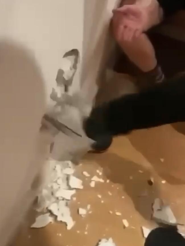 He then kicks a hole in the wall.