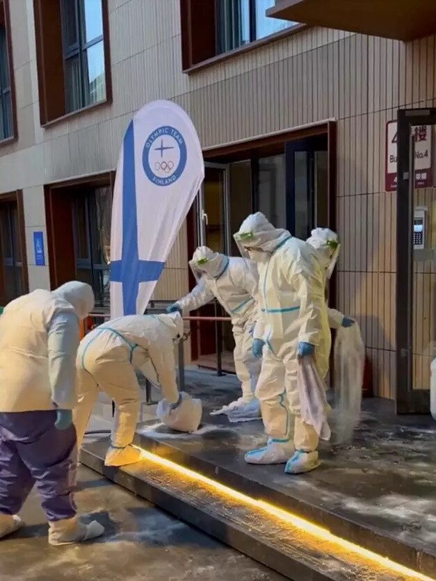 Katri Lylynpera shows a group of workers outside the Olympics village. Photo: Instagram, @katrilylynpera.