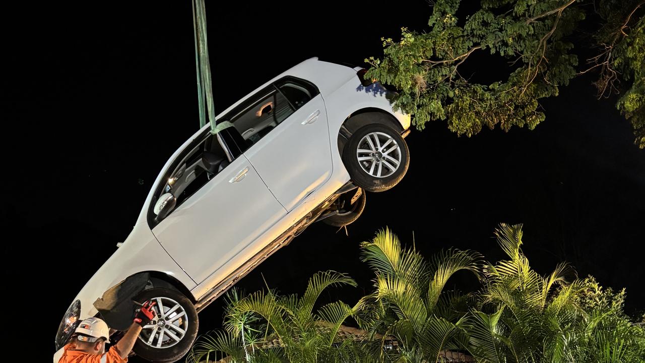 WATCH: Woman freed, car lifted after ploughing into roof of Brisbane home