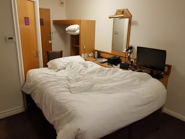 Jake Archer came up with the perfect solution to the first world problem of not having a plug socket near his hotel bed — by rearranging the Premier Inn room entirely. Photo: Mercury Press