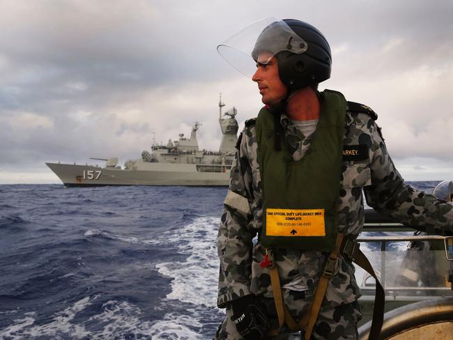 Leading Seaman, Boatswain's Mate, William Sharkey searching for debris on a rigid hull inflatable boat as the HMAS Perth searches for missing Malaysia Airlines flight MH370. Picture: AFP/Australian Defence /ABIS Nicolas Gonzalez