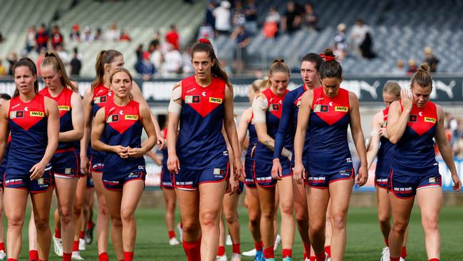 MELBOURNE, AUSTRALIA – NOVEMBER 19: The Demons leave the field after a loss during the 2023 AFLW Second Semi Final match between The Melbourne Demons and The Geelong Cats at IKON Park on November 19, 2023 in Melbourne, Australia. (Photo by Dylan Burns/AFL Photos via Getty Images)