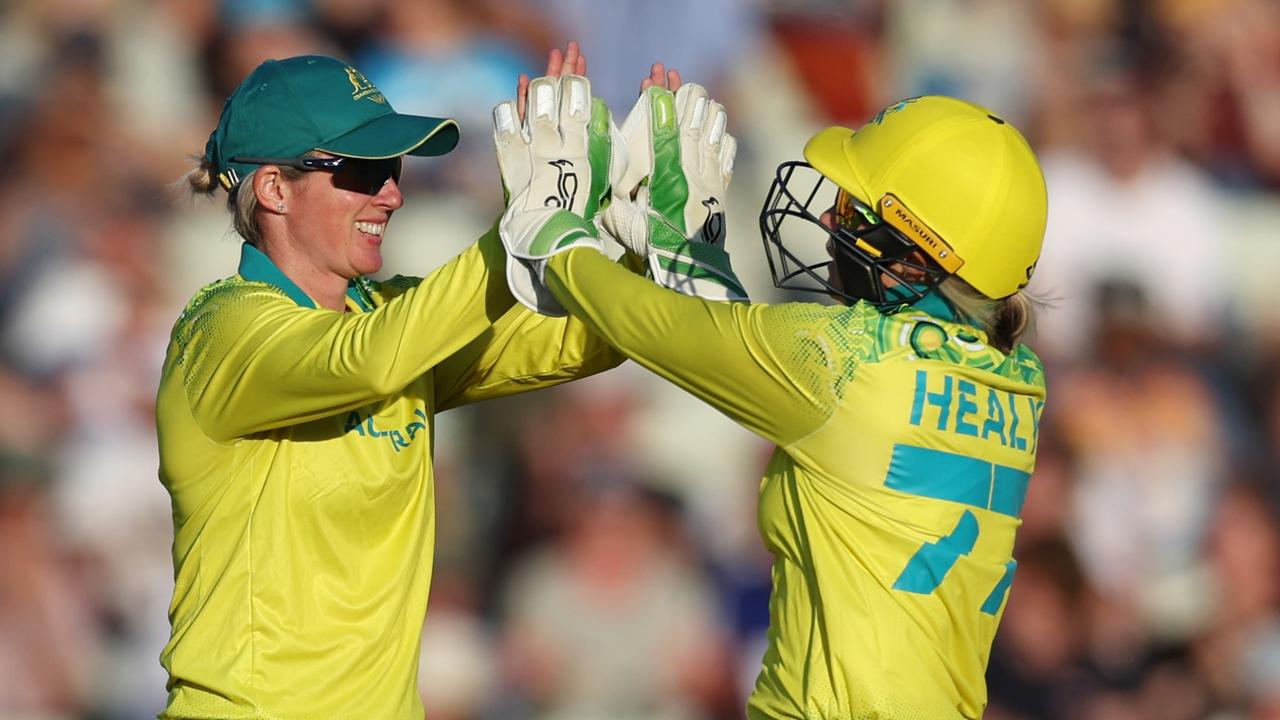 Beth Mooney and Alyssa Healy celebrate a wicket.