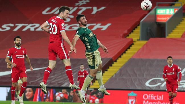 Liverpool's Portuguese striker Diogo Jota heads in the winner against Sheffield United
