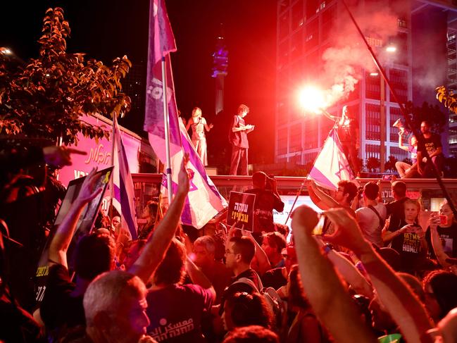 Israeli anti-government demonstrators hold placards and wave national flags during a protest calling for action to secure the release of Israeli hostages held captive since the October 7 attacks by Palestinian militants in the Gaza Strip, in front of the Israeli Defence Ministry in Tel Aviv on September 5, 2024, amid the ongoing war between Israel and the militant Hamas group. During the October 7 attack by Hamas on Israel, militants seized 251 people, 97 of whom are still held captive in Gaza, including 33 the military says are dead. (Photo by Jack GUEZ / AFP)