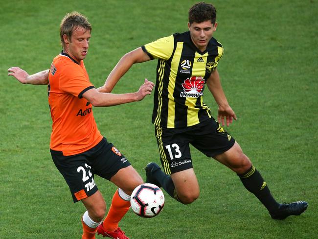 Tobias Mikkelsen of the Roar (left) and Liberato Cacace of the Phoenix compete for the ball on Saturday. Picture: Getty Images 