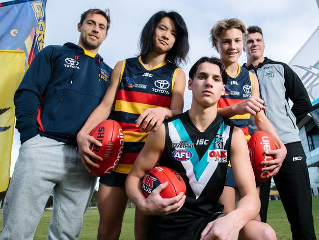 Crows Next Generation Academy mentor Richard Douglas with Foster Mesecke, 14, Harper Montgomery, 15, Archie Lovelock, 14, and Port Adelaide’s Next Generation Academy coach Paul Stewart. Picture: The Advertiser/Morgan Sette