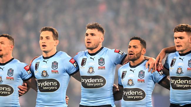 The New South Wales players embrace for their national anthem before game three of the State of Origin Series between the Queensland Maroons and the New South Wales Blues at Suncorp Stadium on July 13, 2022, in Brisbane, Australia. (Photo by Bradley Kanaris/Getty Images)