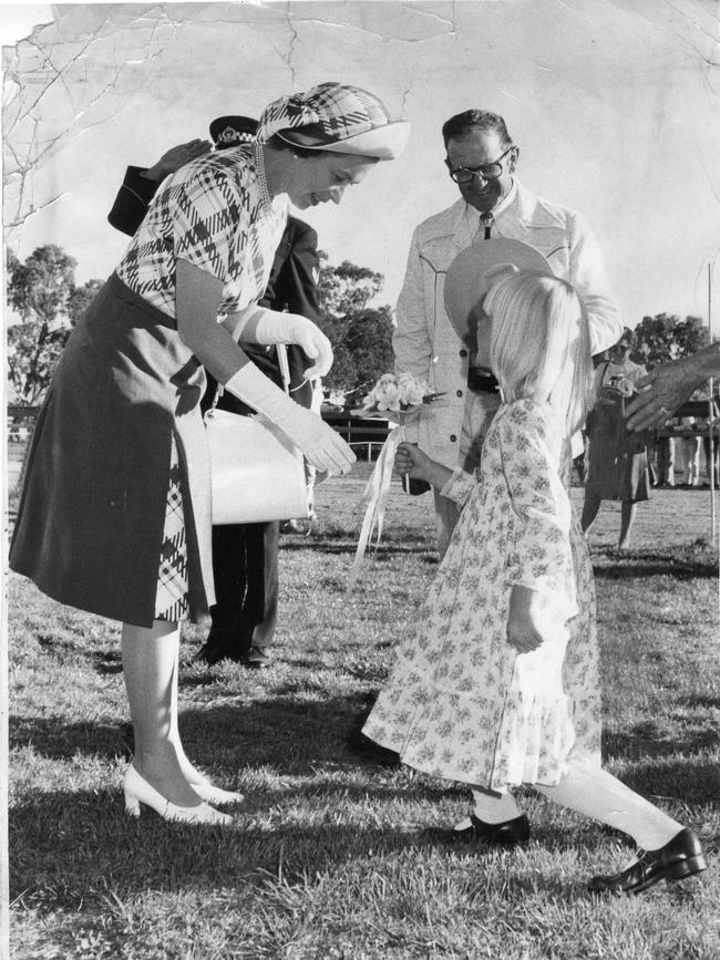 Tracey Carter, 5, presents a bouquet of flowers to the Queen during her visit to the Willomurra Stud, near Kersbrook in 1977.