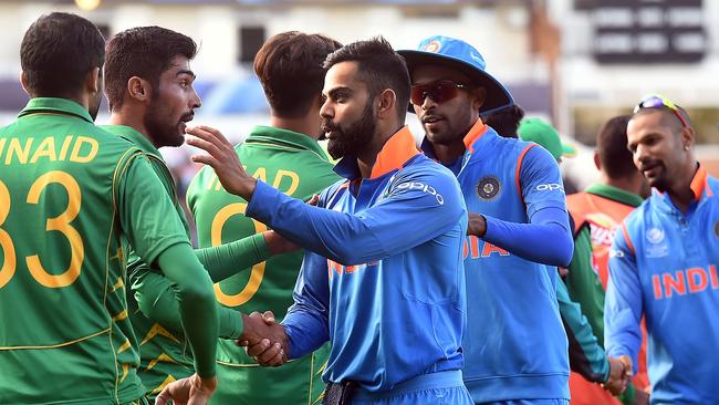 India's captain Virat Kohli (C) shakes hands with Pakistan players after the heavy win.