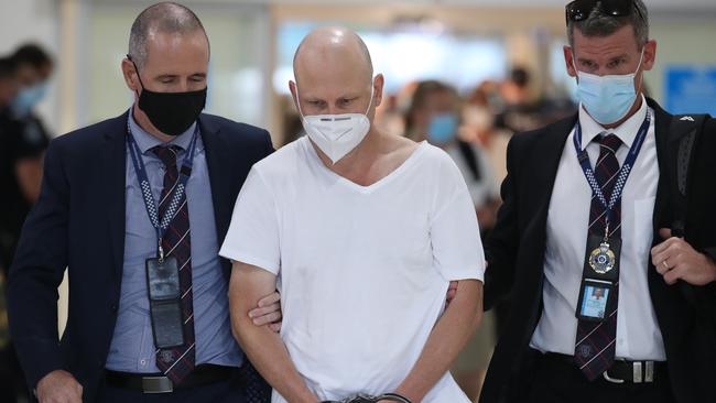 Ex-snooker champion Michael Tillman with police at the Gold Coast Airport. Picture Glenn Hampson