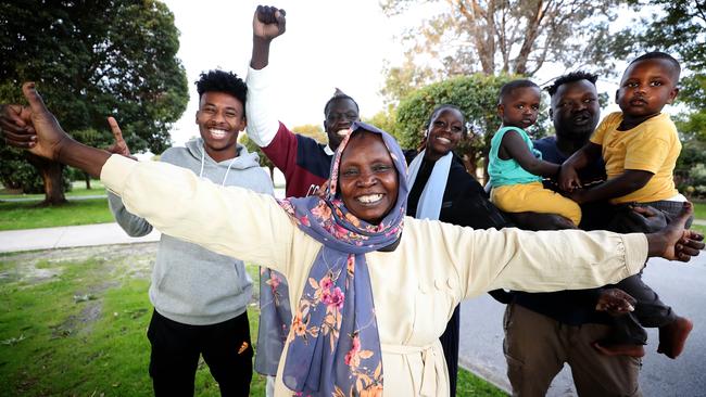 The extended Bol clan surround mother Hanan Kuku: cousin Abra, left, brother Izeldin, sister Nijbol, and eldest brother Moh, holding sons Abdalla and Alli. Picture: Colin Murty