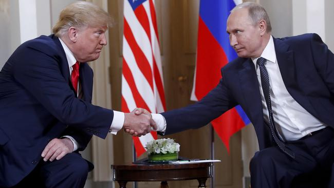 Donald Trump and Russian President Vladimir Putin shake hands at the beginning of a meeting at the Presidential Palace in Helsinki, Finland, in July.