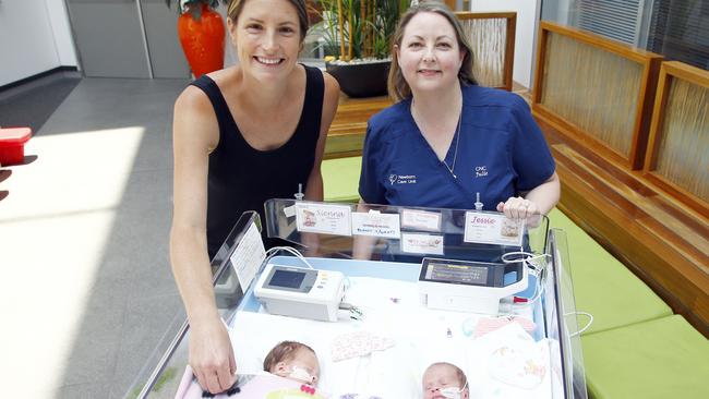 Mum of four Kylie Symington, left, and with Gold Coast University Hospital clinical nurse consultant Julie Dunsmuir with twins Sienna and Jessie at the NICU ward. Picture: Tertius Pickard