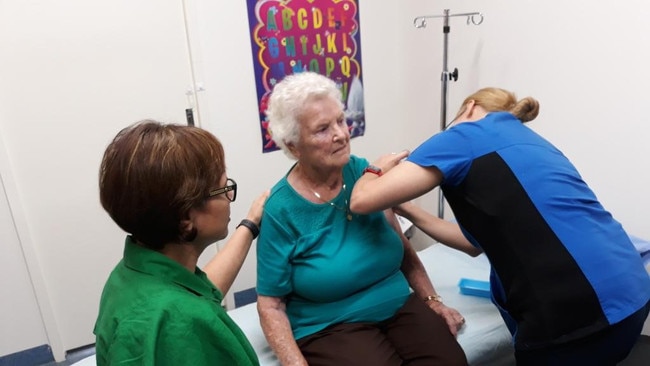 Doctor Harpreet Grover supports Elsie Clarke as registered nurse Freyja Arroylo administers the COVID vaccination at Gladstone Medical Centre this week.