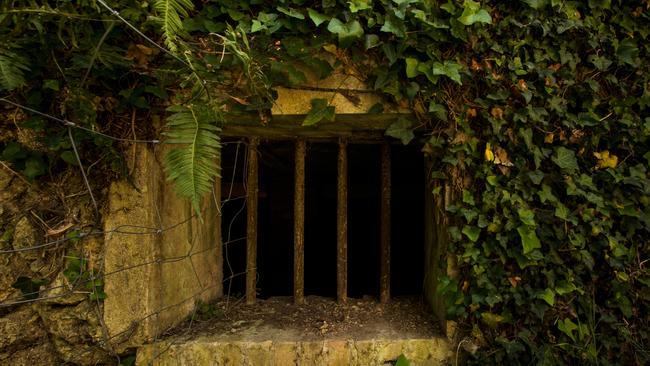 Barred windows speak of an eerie past. Picture: Seph Lawless