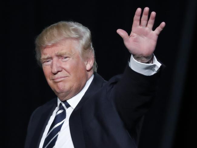 Republican presidential candidate Donald Trump waves to the audience exiting a campaign rally in Grand Rapids, Mich., Tuesday, Nov. 8, 2016. (AP Photo/Paul Sancya)