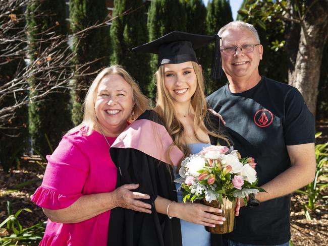 Bachelor of Education (Primary) graduate Beth Curtis is congratulated by parents Helen Proctor-Curtis and Steve Curtis at a UniSQ graduation ceremony at Empire Theatres, Tuesday, June 27, 2023. Picture: Kevin Farmer