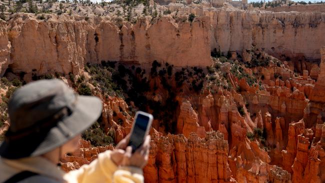 Crowds are not a problem ... A tourist takes a photo at Bryce Canyon National Park in Bryce Canyon City, Utah. Picture: Bloomberg