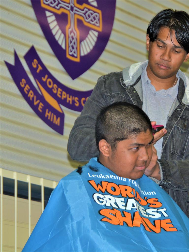 At the St Joseph's College 2023 World's Greatest Shave event is student Johann Ferrer getting his hair cut by his older brother Jeffrey Ferrer. Picture: Rhylea Millar