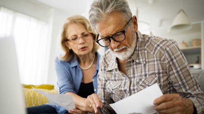 Shot of a senior couple looking stressed while going over their finances at home; wealth superannuation worries generic bills