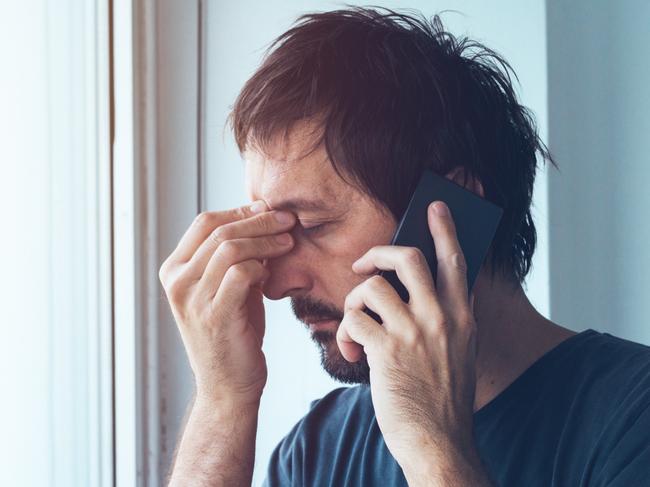 Phone call, generic, worried, anxious man talking with someone on mobile phone.