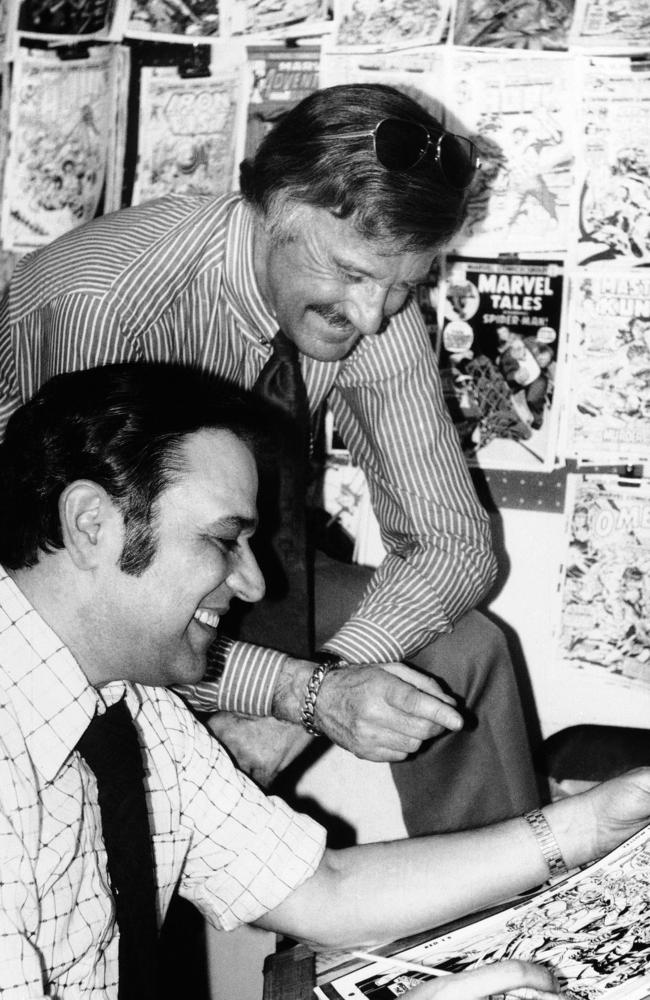 Stan Lee in 1976 discusses a Spiderman comic book cover with artist John Romita at Marvel headquarters in New York. Picture: AP