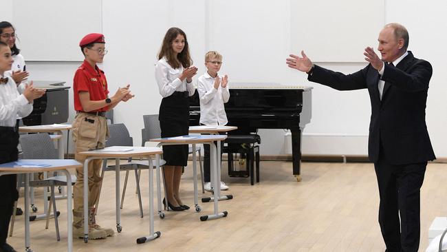 He regaled them with an odd joke about a “rubber bum”. (Photo by Gavriil GRIGOROV / SPUTNIK / AFP)