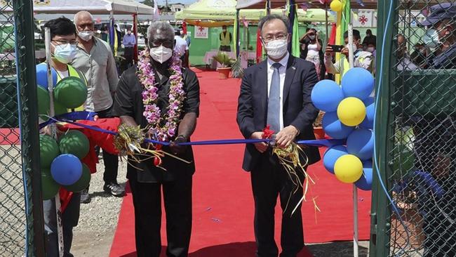 Chinese ambassador to the Solomon Islands Li Ming, right. and Mr Sogavare cut a ribbon during the opening ceremony of a China-funded $74 million national stadium complex in Honiara in April. Picture: Chinese Embassy of Solomon Islands