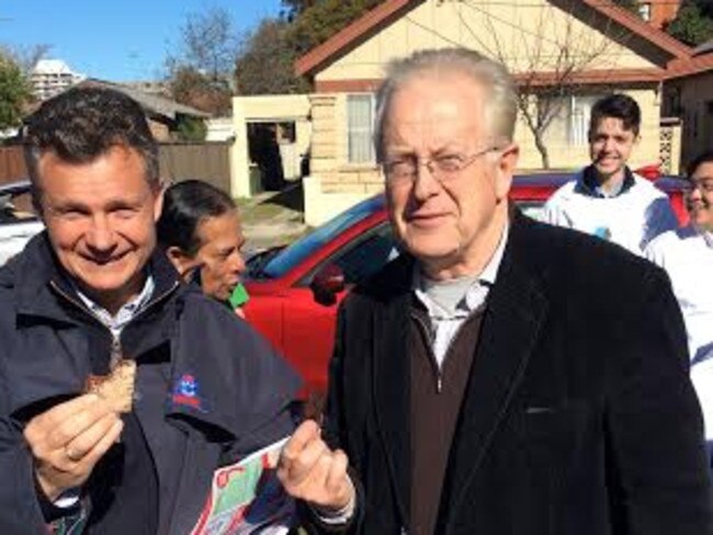 Labor MP Matt Thistlethwaite shouted his opposite number Liberal candidate Michael Feneley a brownie from the cake stall at Maroubra Junction Public School as the political rivals greet voters at the gate