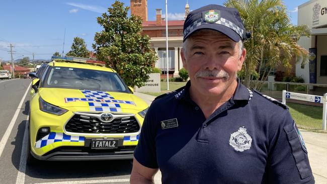 Gympie traffic officer-in-charge Chris Watson, with one of the state's yellow “fatal five” police cars, which was parked outside traffic court on Thursday, September 7, is pleading for people to take care on Wide Bay roads as the death toll soars.