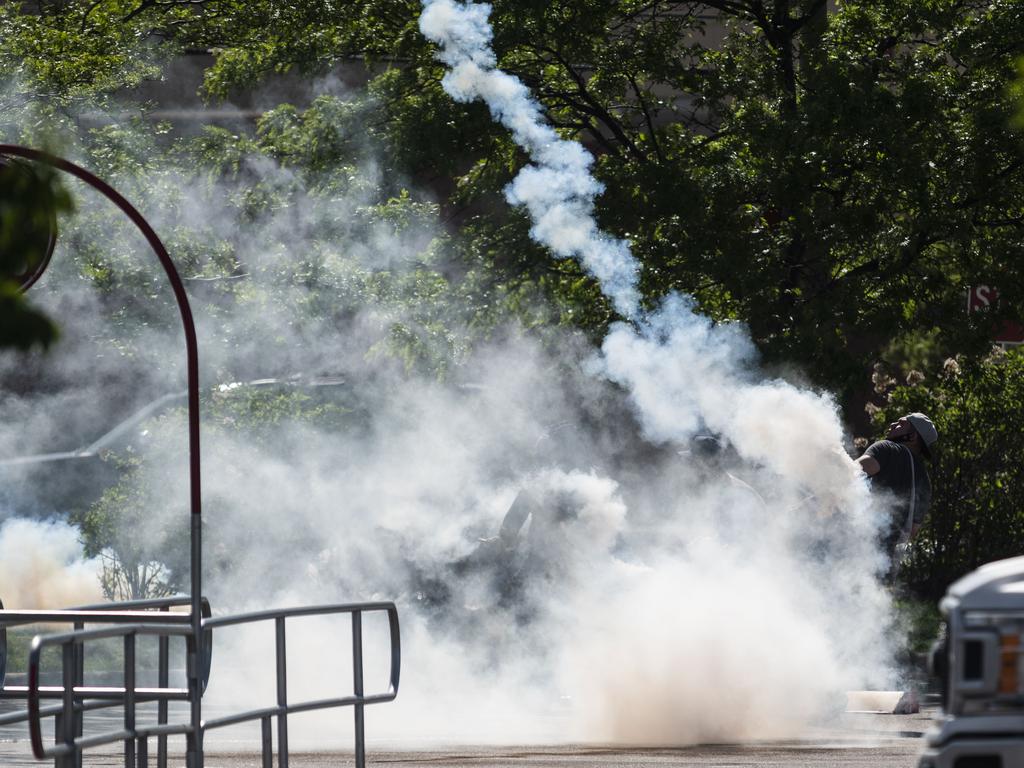 A man hurls a tear gas canister at police in a Target store. Picture: Stephen Maturen/Getty Images/AFP.