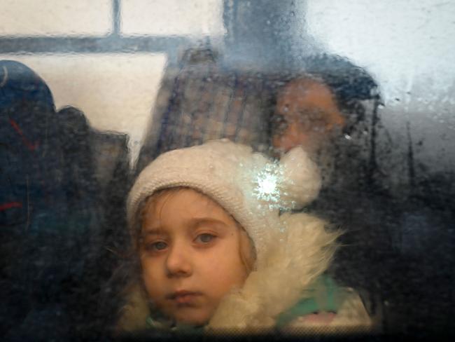 A girl fleeing the conflict in Ukraine looks on from inside of a bus heading to the Moldovan capital Chisinau. Picture: AFP