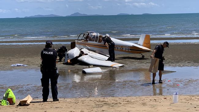 Investigators inspect the wreckage of a plane that crashed at Ball Bay claiming the life of the 83-year-old passenger. Photo: Janessa Ekert