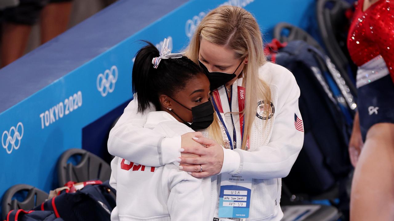 TOKYO, JAPAN - JULY 27: Simone Biles of Team United States is embraced by coach Cecile Landi during the Women's Team Final on day four of the Tokyo 2020 Olympic Games at Ariake Gymnastics Centre on July 27, 2021 in Tokyo, Japan. (Photo by Jamie Squire/Getty Images)