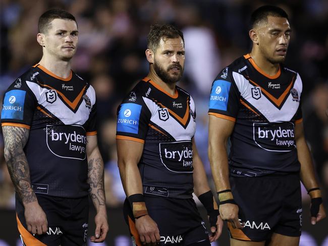 SYDNEY, AUSTRALIA - JULY 12: John Bateman and Aidan Sezer of the Wests Tigers react after a Sharks try during the round 19 NRL match between Cronulla Sharks and Wests Tigers at PointsBet Stadium on July 12, 2024, in Sydney, Australia. (Photo by Brendon Thorne/Getty Images)