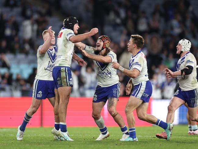 SYDNEY, AUSTRALIA - JUNE 28:  Matt Burton of the Bulldogs celebrates with team mates after kicking a golden point field goal in extra time to win the round 17 NRL match between Canterbury Bulldogs and Cronulla Sharks at Accor Stadium on June 28, 2024, in Sydney, Australia. (Photo by Cameron Spencer/Getty Images)