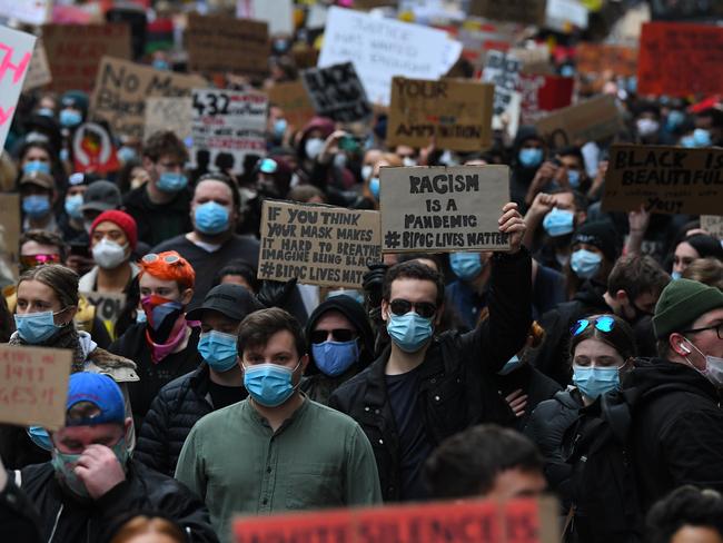 Protesters are seen a Black Lives Matter rally in Melbourne, Saturday, June 6, 2020. Thousands of protesters are expected at theÃÂ rallyÃÂ in centralÃÂ Melbourne on Saturday out of solidarity with the Black Lives Matter movement in the United States and to call for an end to Aboriginal deaths in police custody. (AAP Image/James Ross) NO ARCHIVING