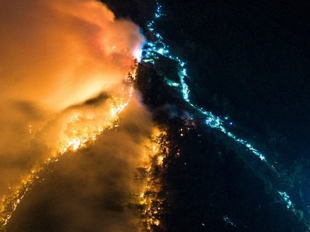 The blue lights show people with head lamps battling the fire in Chongqing. Picture: Twitter