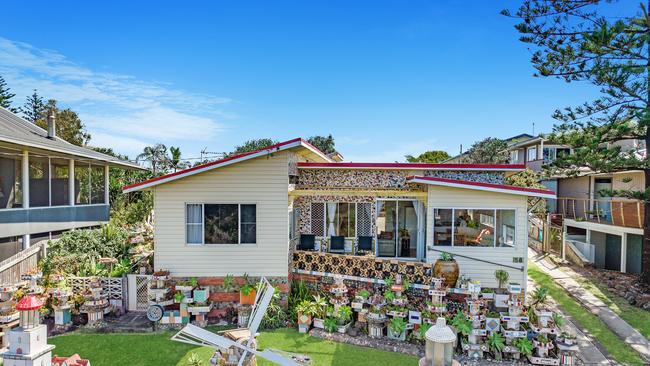 WINDMILL HOUSE: Generations of people of stopped to admire this house at 58 Shelley Beach Rd, Ballina which was decorated by former owner Peter Gutter with quirky tiled and decorated objects.