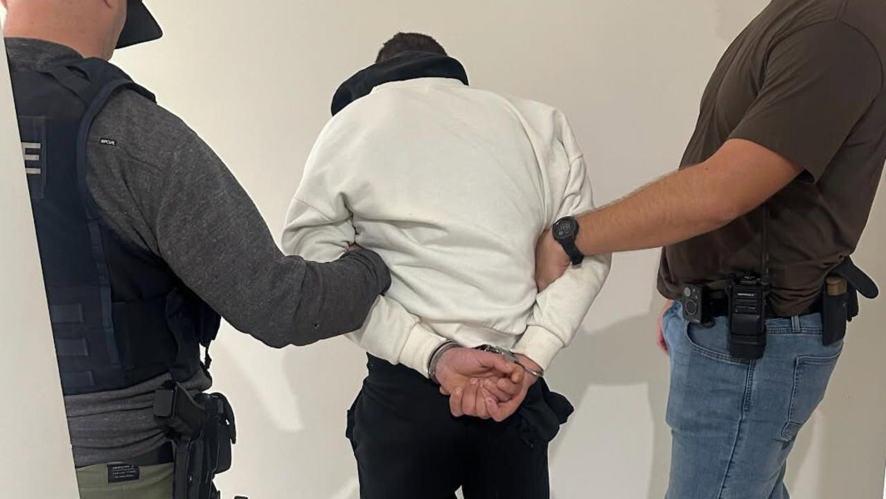 Wanted man captured ‘hiding’ behind door at resort