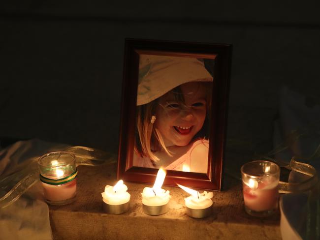 Candles light a photograph of Madeleine McCann inside the church of Praia da Luz, near Lagos, during a mass ceremony marking the 10th anniversary of her disappearance in May. Picture: AFP