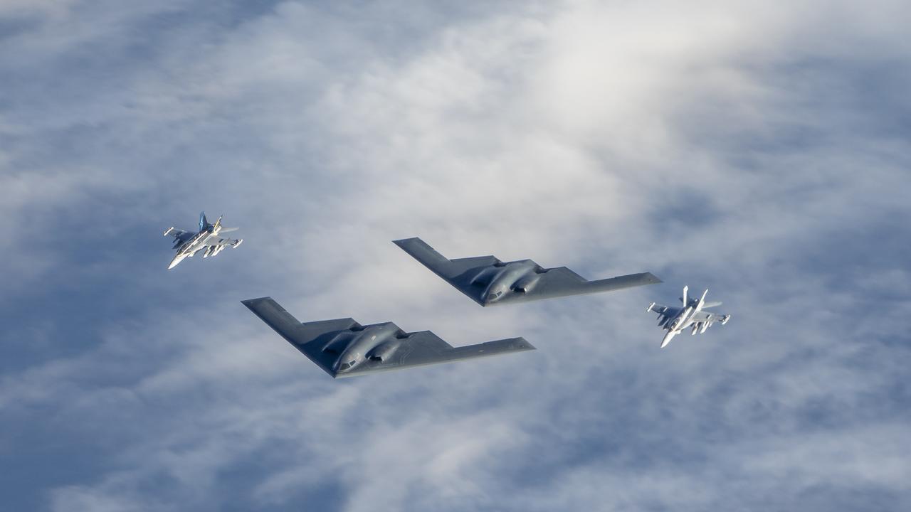 Two Royal Australian Air Force EA-18G Growler jets fly in formation with two United States air force B-2 Bomber aircraft. Picture: FSGT Christopher Dickson