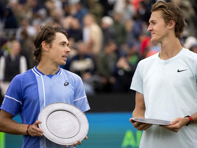 Asutralia's Alex de Minaur (L) celebrates with the trophy after winning against US' Sebastien Korda after their men's singles final match of Rosmalen Grass Court Championships tennis tournament in Rosmalen, near Hertogenbosch, on June 16, 2024. (Photo by Sander Koning / ANP / AFP) / Netherlands OUT