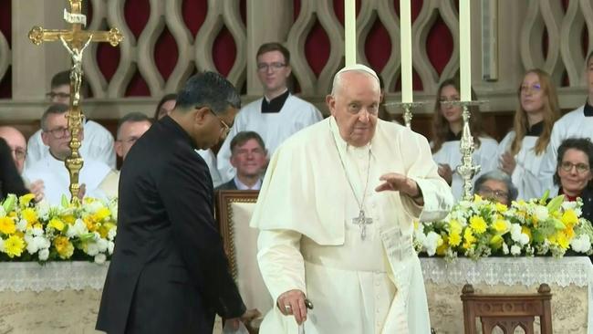 Pope Francis (C) gestures while being greeted by King Philippe (L) and Queen Mathide of Belgium (3rd R) during a welcoming ceremony upon arrival at Melsbroek Air Base